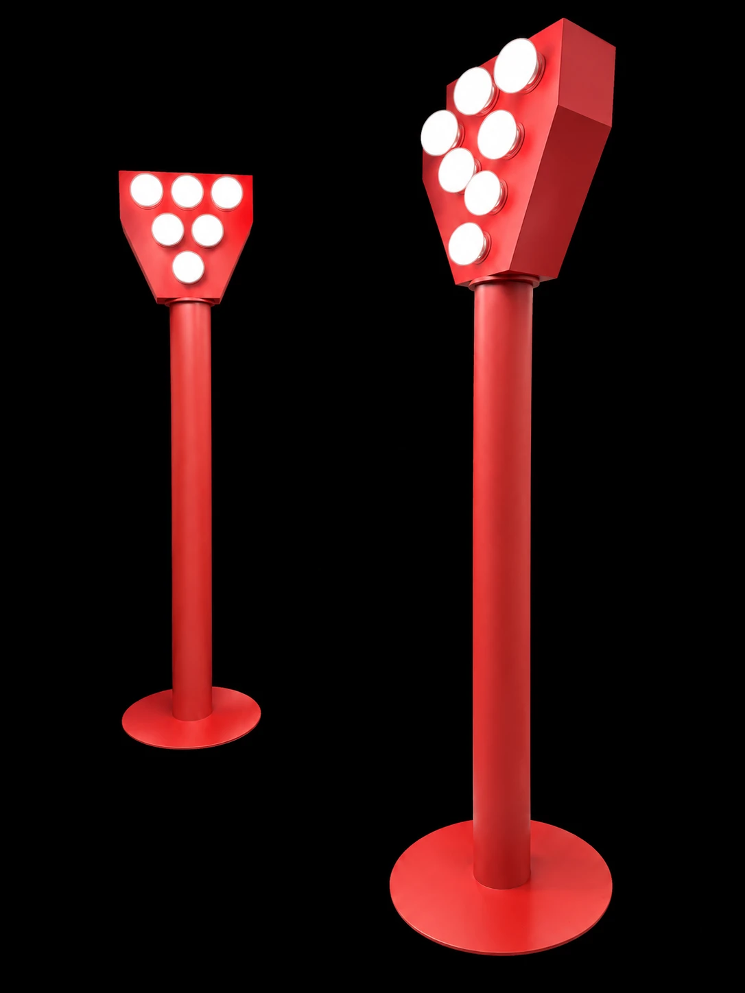 Two freestanding red light towers with circular white lamps on round bases